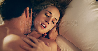 Buy stock photo High angle shot of a young couple being intimate in their bedroom