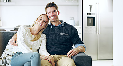 Buy stock photo Cropped portrait of an affectionate young couple sitting on their sofa at home
