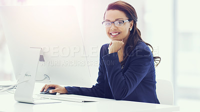 Buy stock photo Cropped portrait of an attractive young businesswoman working on her computer in the office