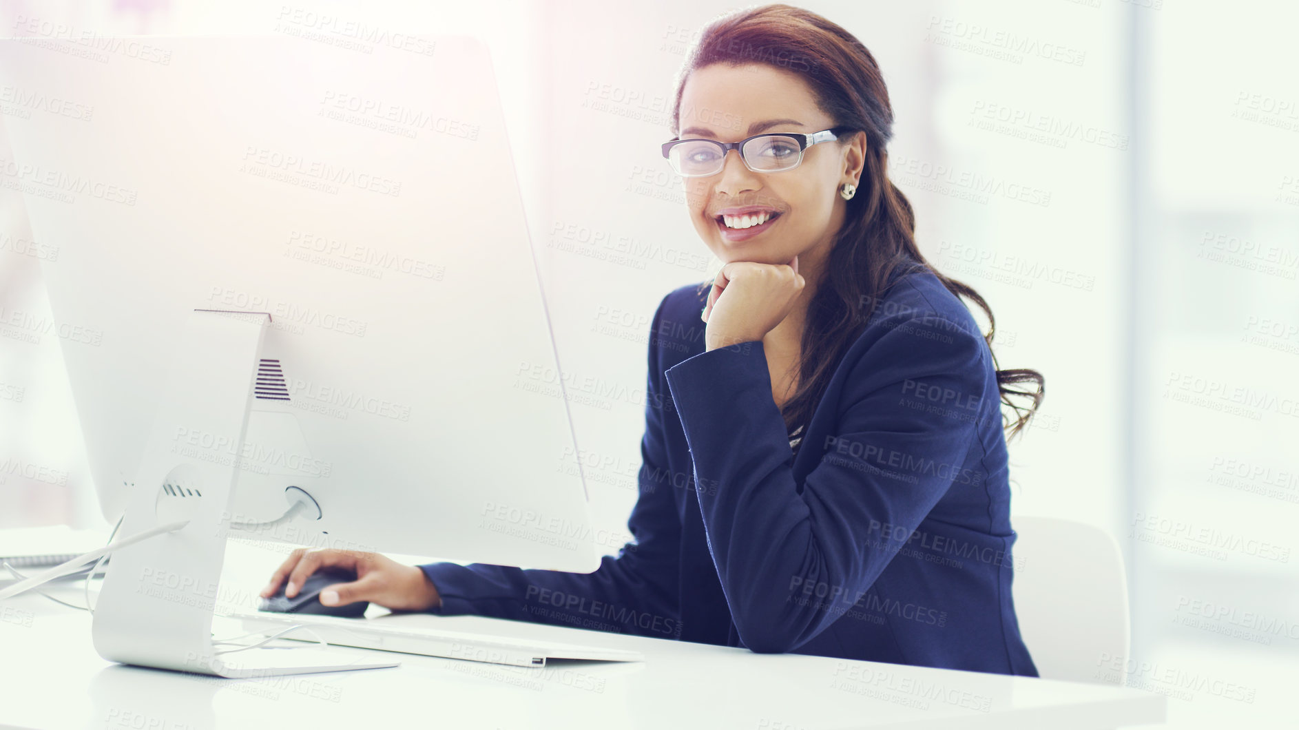 Buy stock photo Cropped portrait of an attractive young businesswoman working on her computer in the office