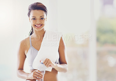 Buy stock photo Cropped portrait of an attractive young woman taking a water break during her workout at home