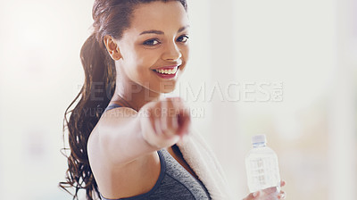 Buy stock photo Cropped portrait of an attractive young woman pointing towards the camera during her workout at home