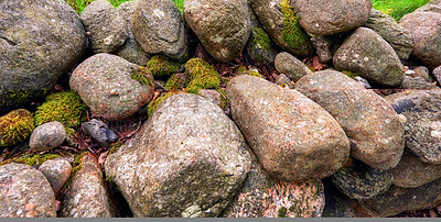 Buy stock photo Closeup of many big rocks covered in lichen. Landscape of green moss contrasting on pile of weathered stones in the wild or uncultivated environment. Beautiful details of rough rocky nature textures