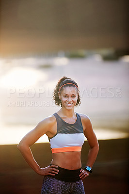 Buy stock photo Cropped portrait of an attractive young woman taking a run through the city