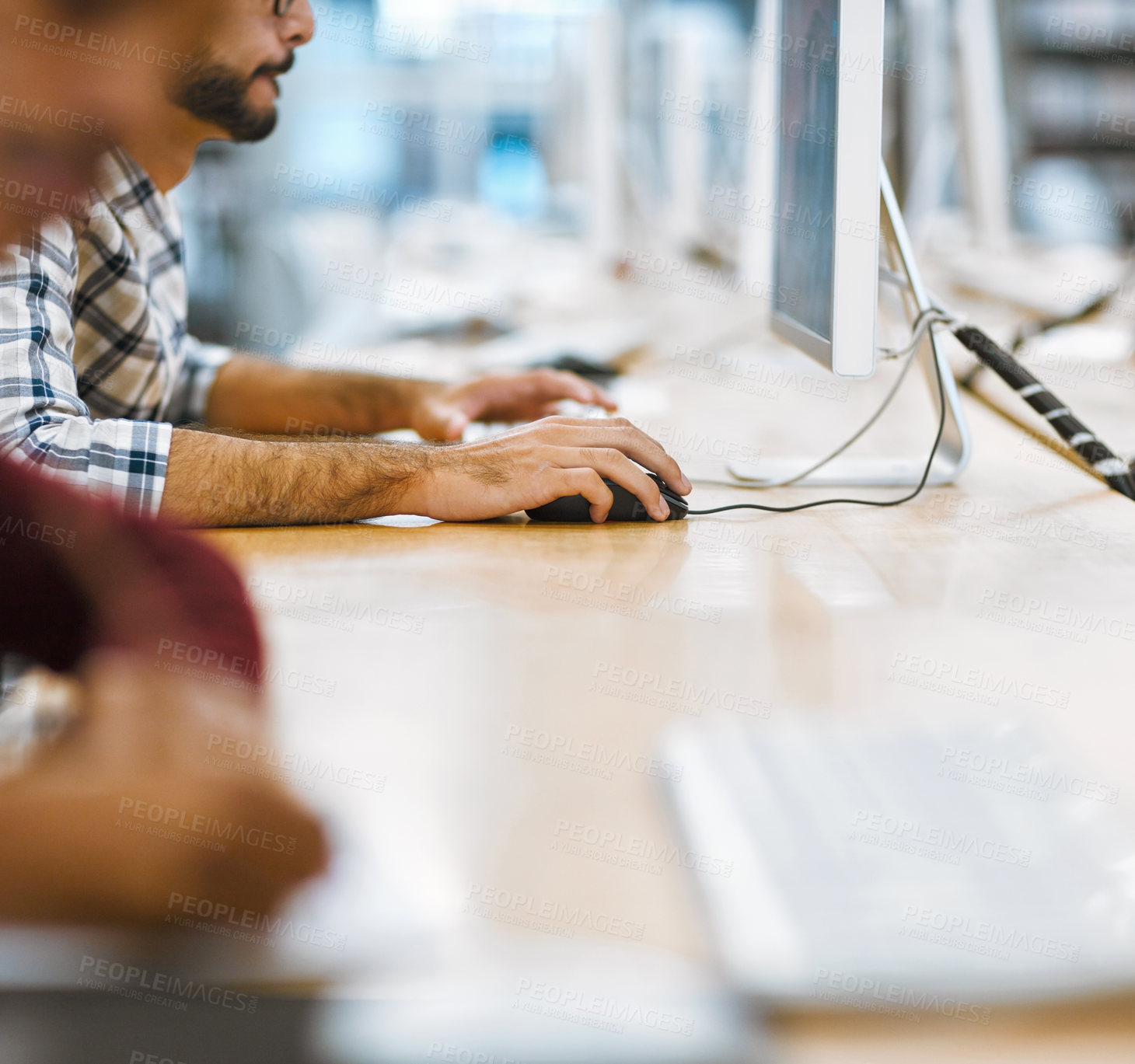 Buy stock photo Shot of two unrecognizable students working on computers in the library to prepare for exams