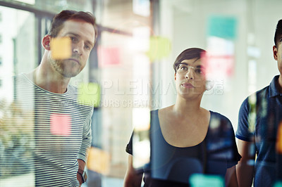 Buy stock photo Manager, leader or boss talking and planning in a workshop, seminar or presentation with sticky notes in a boardroom. Business woman discussing and brainstorming with her colleagues and coworkers