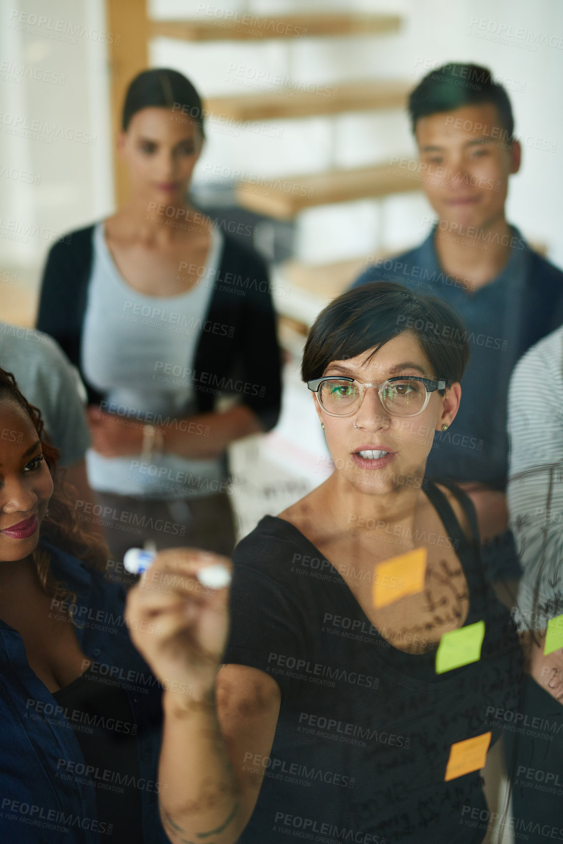 Buy stock photo Brainstorming, diverse and creative team writing a strategy idea on sticky notes and creating a schedule on a glass board. Group using teamwork, planning and collaboration in a marketing meeting