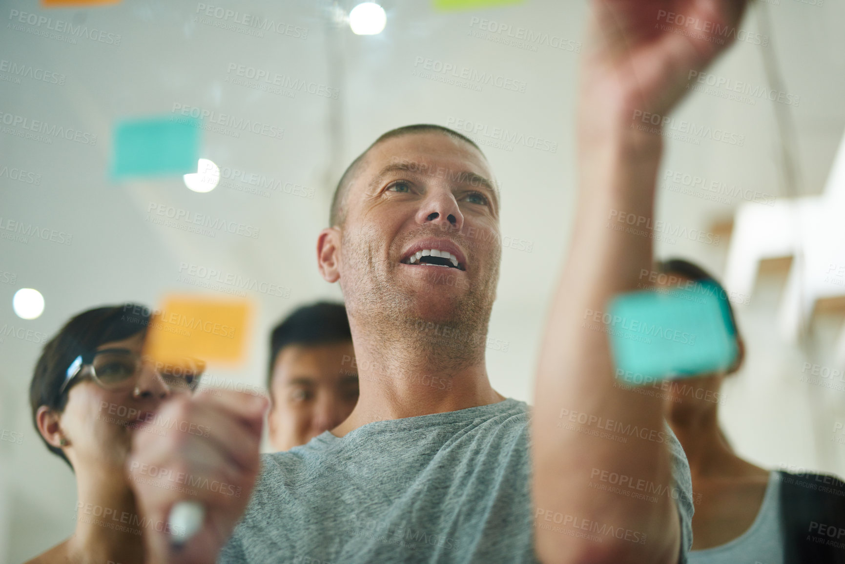 Buy stock photo Manager brainstorming, planning in a corporate team meeting showing leadership, management skills in the workplace. Business colleagues writing project strategy on sticky notes in office environment