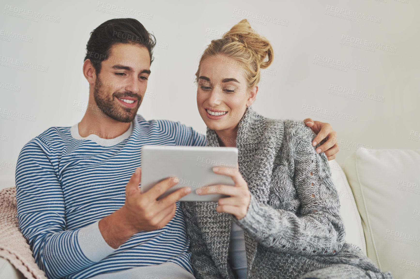 Buy stock photo Couple, reading or tablet for movie, news and streaming choice online on couch in living room. Technology, internet or people in lounge on social network app on digital website or touchscreen in home