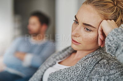 Buy stock photo Cropped shot of an unhappy young couple after a fight at home