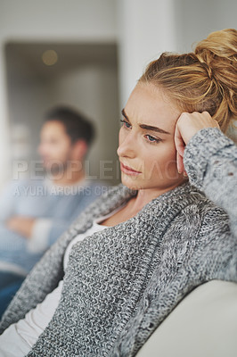 Buy stock photo Sad, depression and woman in conflict with her boyfriend in the living room of their apartment. Upset, disappointed and moody female person in argument, fight or breakup with partner at their home.