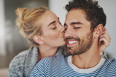 Buy stock photo Cropped shot of an affectionate young couple relaxing at home