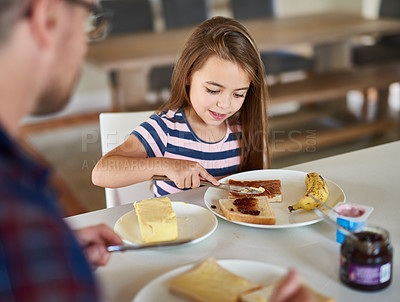 Buy stock photo Cropped shot of an adorable little girl having breakfast
