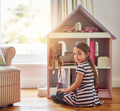 Buy stock photo Shot of a little girl playing with a dollhouse at home