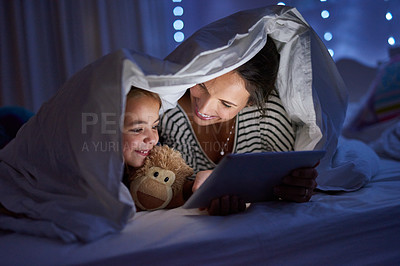 Buy stock photo Cropped shot of an attractive young woman reading her daughter a bedtime story