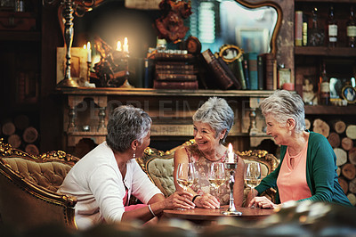 Buy stock photo Relax, wine and laugh with elderly friends in home for bonding, funny and smile. Retirement, diversity and happiness with group of senior female people with drink for social, memory and support