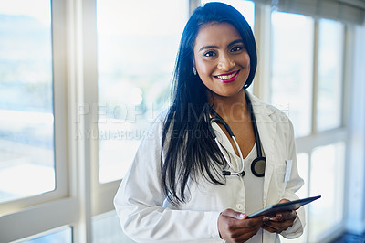Buy stock photo Portrait of a female doctor using a digital tablet in a hospital