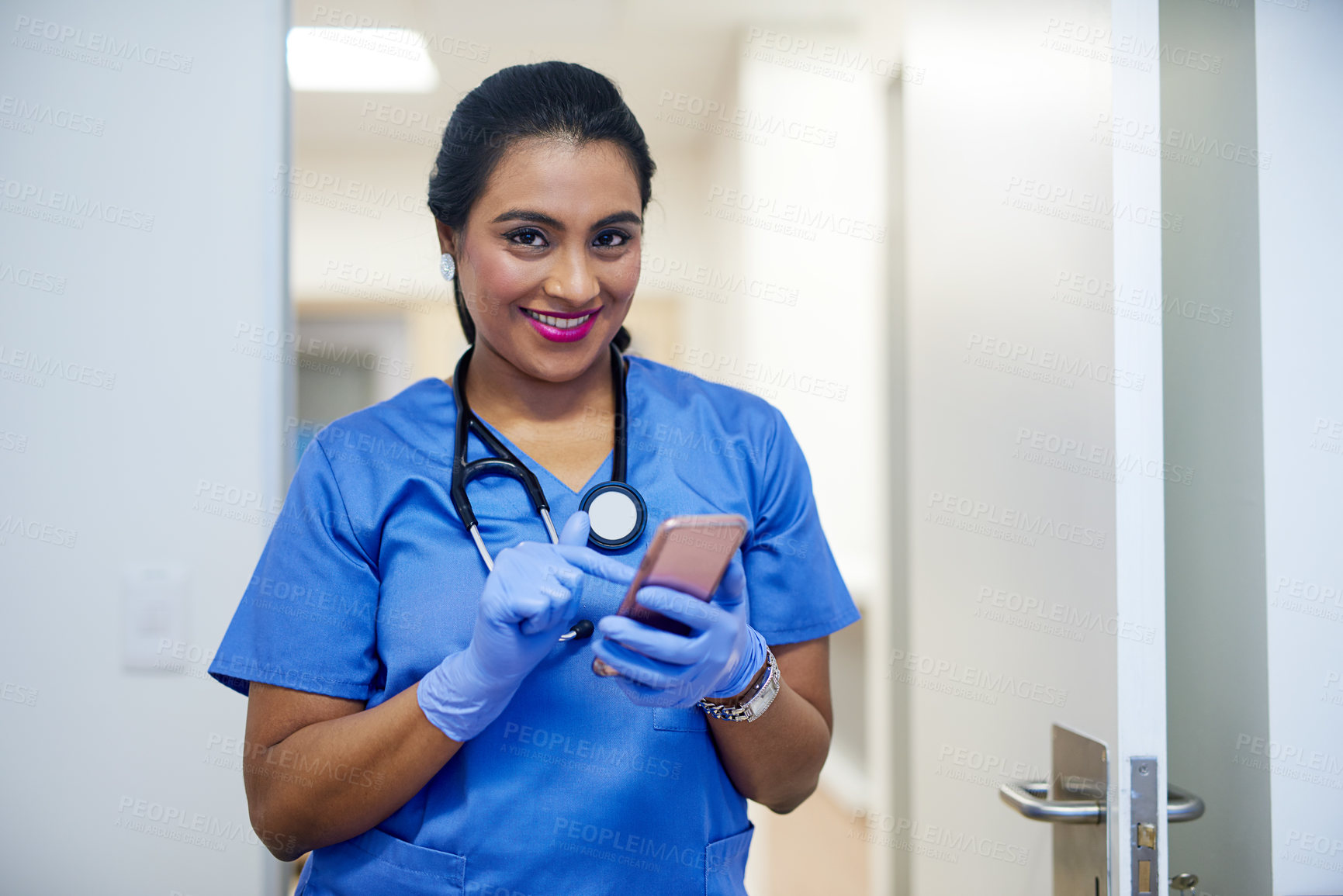 Buy stock photo Portrait of a female surgeon using a cellphone in a hospital