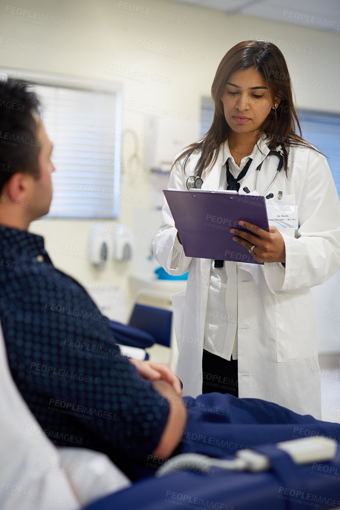 Buy stock photo Shot of a doctor attending to a patient in a hospital