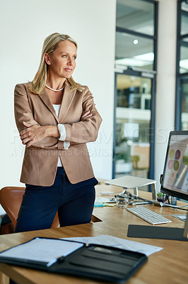 Buy stock photo Shot of a mature businesswoman looking thoughtful while standing in an office