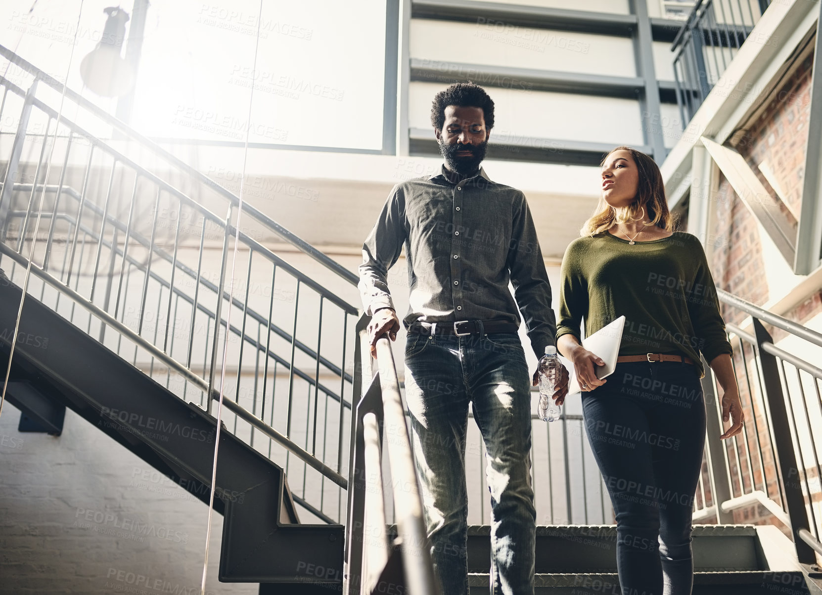 Buy stock photo Walking, stairs and business people in office for meeting, appointment or project presentation. Low Angle, media agency and employees with tablet for collaboration, partnership or conversation