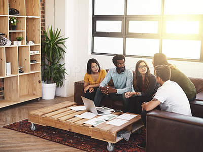 Buy stock photo High angle shot of a group of young designers having a meeting in a modern office