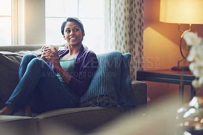 Buy stock photo Thinking, drinking coffee and smile of Indian woman in home living room for morning cup of latte or espresso to relax. Tea, dream or person on sofa for peace, calm or planning future in apartment