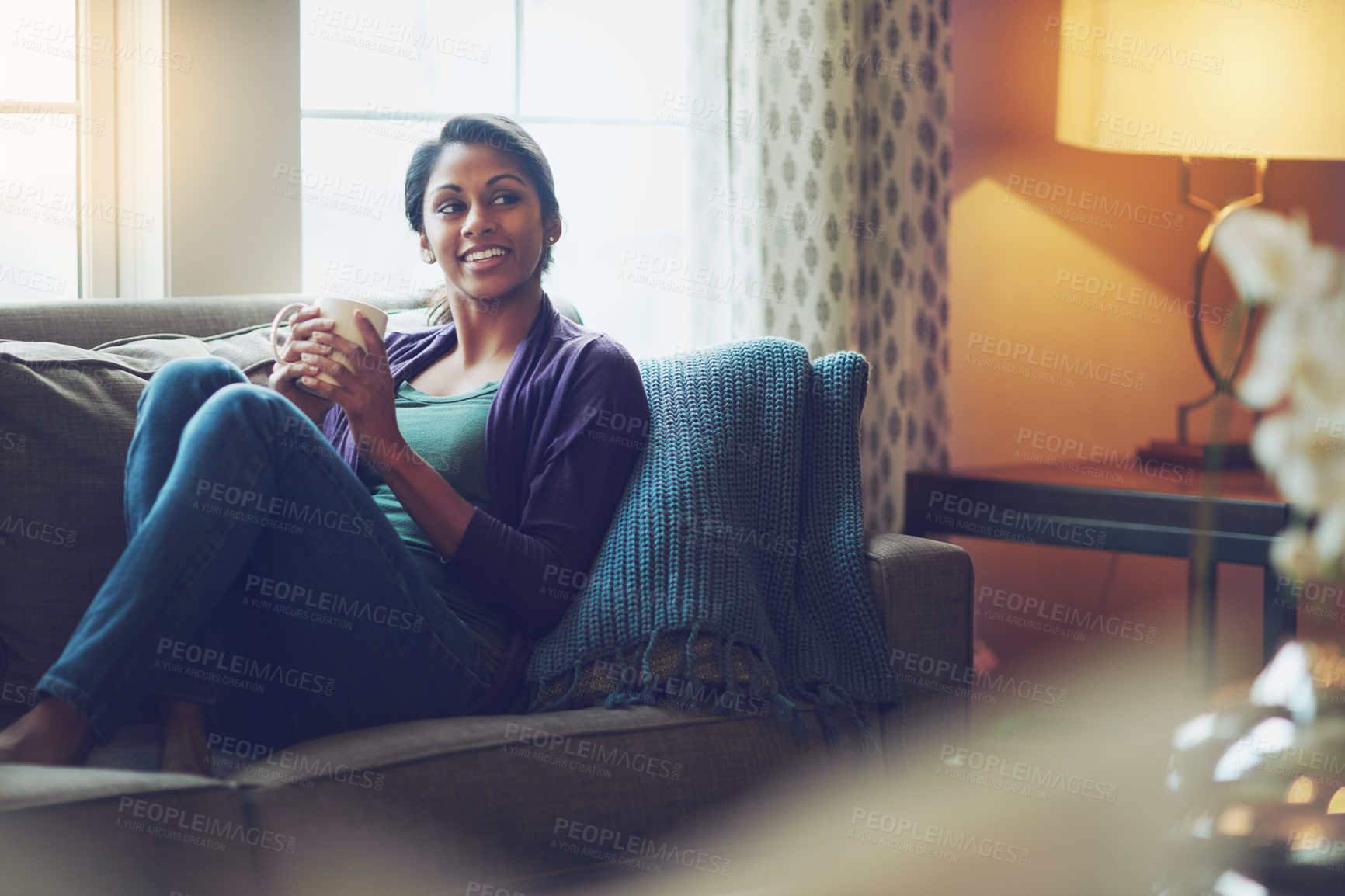 Buy stock photo Thinking, drinking coffee and smile of Indian woman in home living room for morning cup of latte or espresso to relax. Tea, dream or person on sofa for peace, calm or planning future in apartment