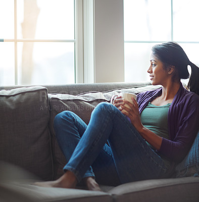 Buy stock photo Thinking, relax and Indian woman drinking coffee in home living room for morning beverage, latte or espresso. Tea, dream and girl on sofa for peace, calm and planning future in comfortable house