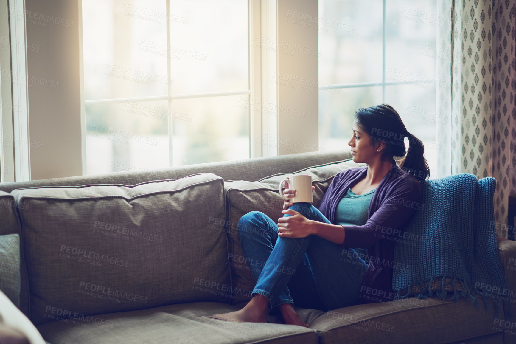 Buy stock photo Thinking, relax and Indian woman drinking coffee in home living room for morning breakfast, latte or espresso. Tea, dream and person on sofa for peace, calm and planning future in comfortable house