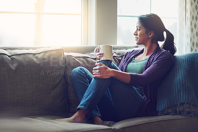 Buy stock photo Thinking, dream and Indian woman drinking coffee in home living room for morning breakfast, latte or espresso. Tea, relax and person on sofa for peace, calm and planning future in comfortable house