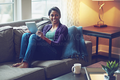 Buy stock photo Woman, tablet and relax on sofa with smile for notification, contact and app in living room. Indian person, touchscreen and streaming with subscription, video and happy on couch with social media