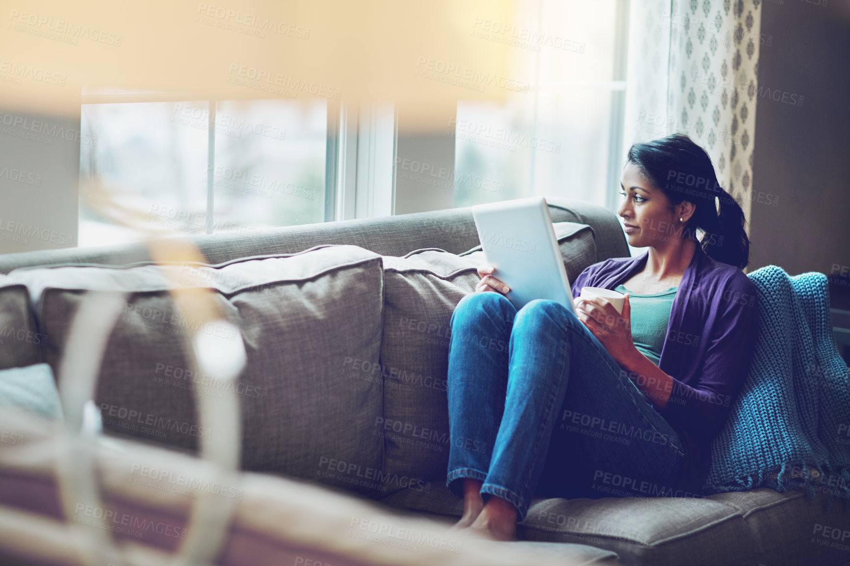 Buy stock photo Coffee, thinking and girl with tablet on a sofa for calm, reflection and relax with social media, streaming or service at home. Digital, memory and woman person with tea a in living room with ebook