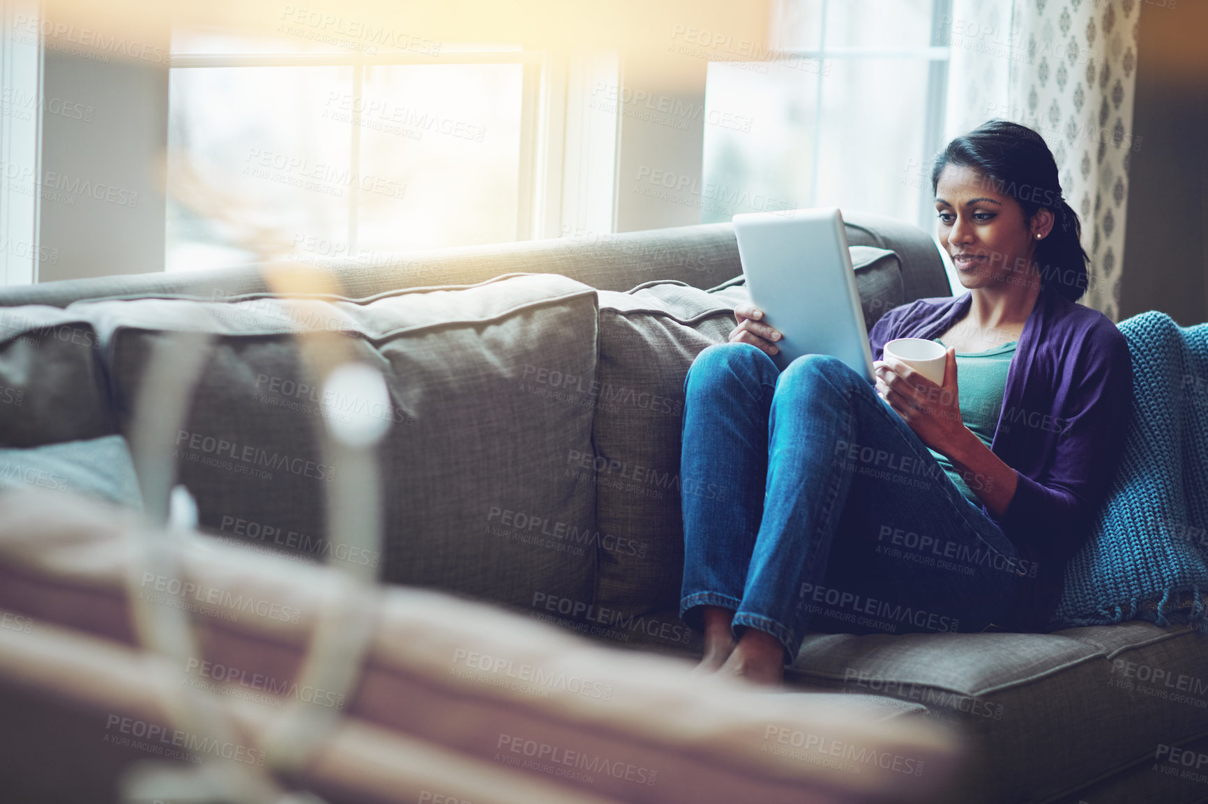 Buy stock photo Woman, home and reading tablet for relax on sofa, scroll on internet or social media. Female person, mobile technology and living room with research and happiness, online blog or email communication