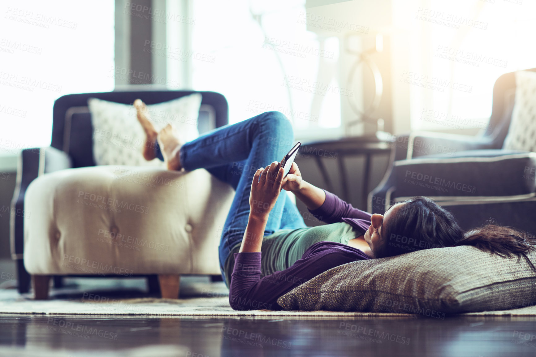 Buy stock photo Happy woman, relax and lying with phone on floor for communication, social media or news at home. Female person on mobile smartphone for online browsing, chatting or texting in living room at house