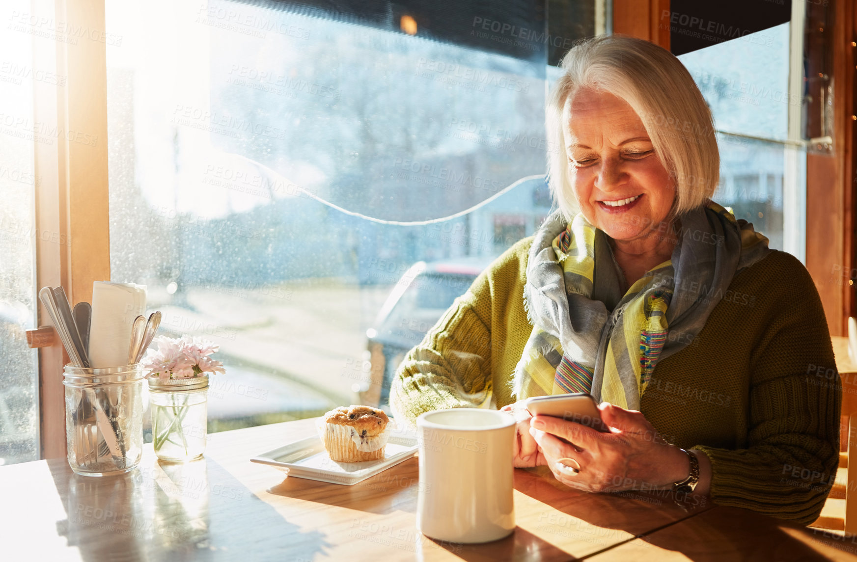 Buy stock photo Senior woman, smartphone and coffee in cafe for breakfast, app and digital menu with happy in city. Elderly person, smile and muffin in Sweden at restaurant with phone for email, chat or internet 