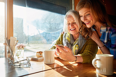 Buy stock photo Mom, daughter and mobile phone in cafe with coffee for social media, internet meme or bonding together. Date, senior lady and woman for networking, communication or online post in restaurant