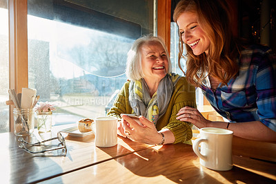 Buy stock photo Mom, daughter and smartphone in cafe with coffee for social media, internet meme or bonding together. Laugh, senior lady and woman with cup for networking, communication or online post in restaurant