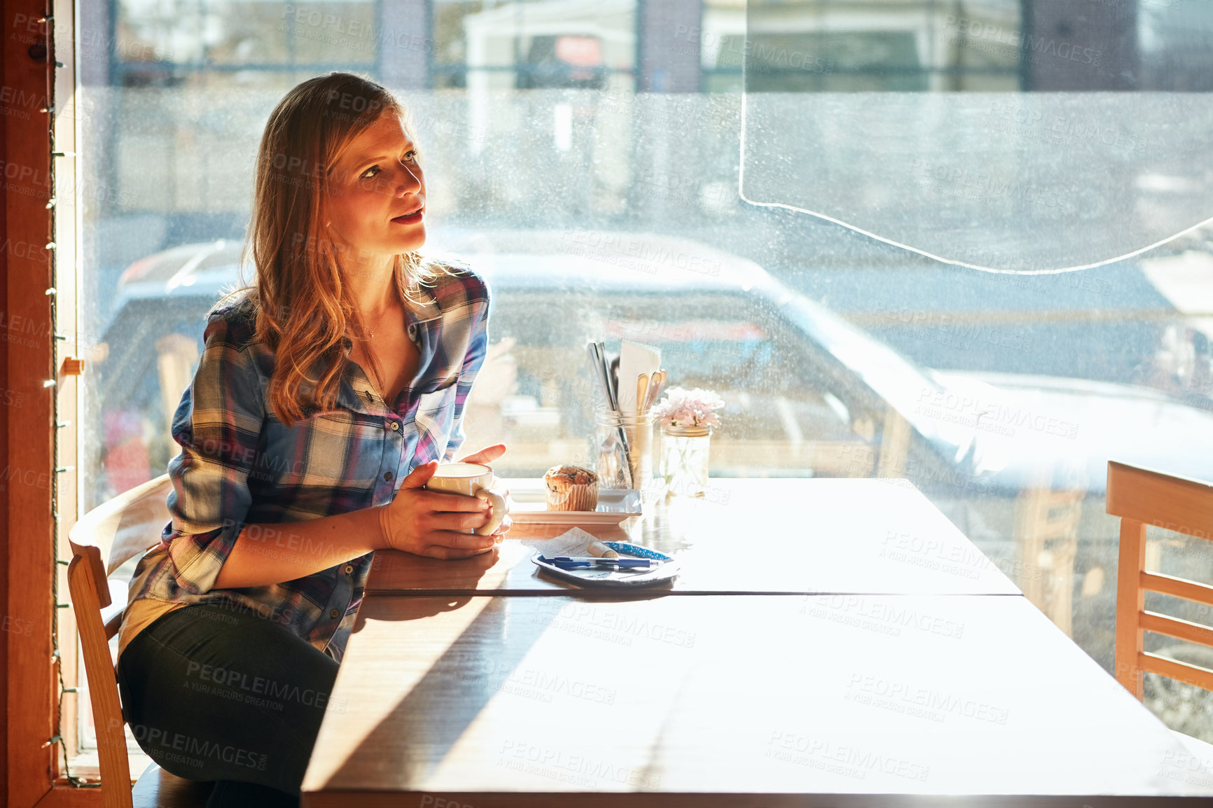 Buy stock photo Shot of an attractive young woman enjoying a cup of coffee in a cafe