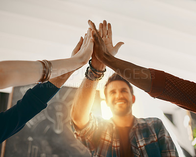 Buy stock photo Shot of creative employees giving each other a high-five in the office