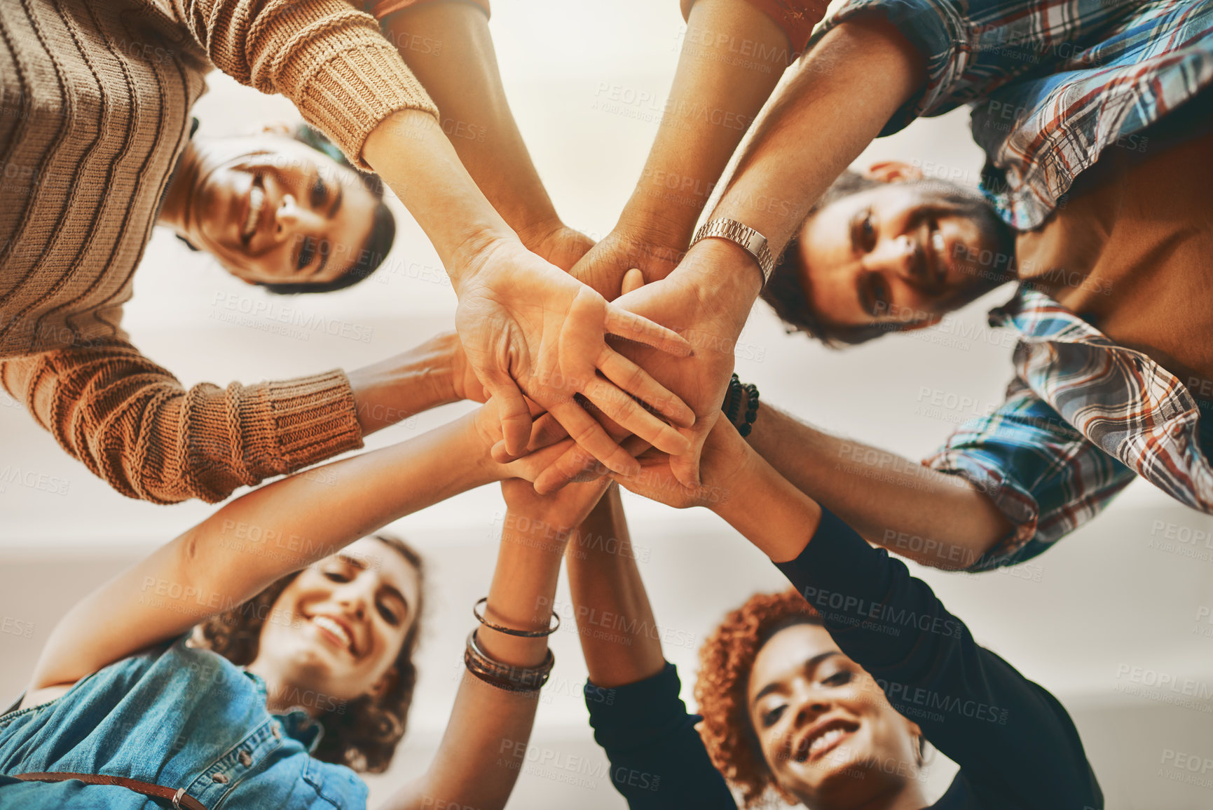 Buy stock photo Portrait, support and hands of business people in stack for collaboration and team building in modern office. Community huddle, low angle and staff synergy for cooperation with partnership and smile