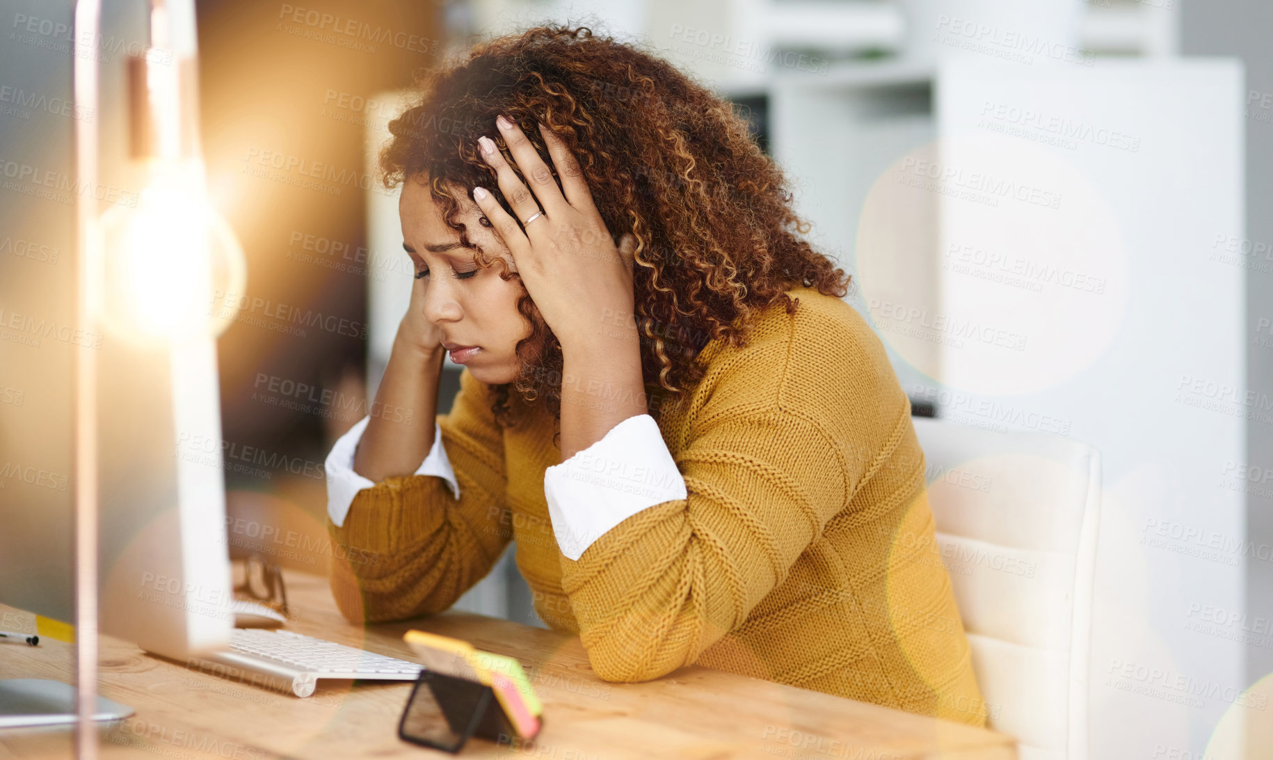 Buy stock photo Shot of a stressed young businesswoman sitting and working in the office at work