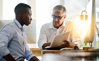 Buy stock photo Shot of two businessmen having a discussion about work related issues in the office