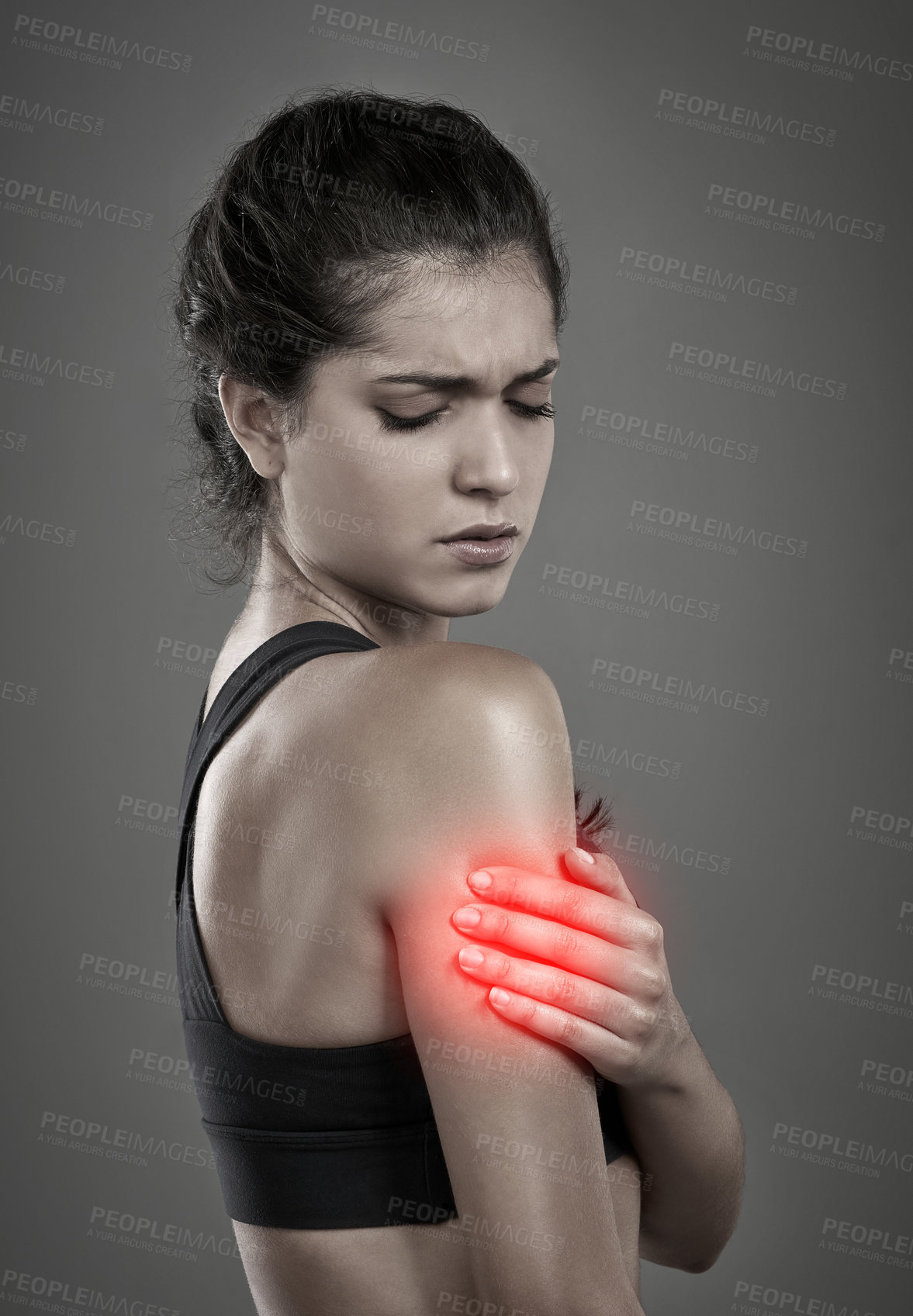 Buy stock photo Studio shot of a young attractive woman holding her injured arm that gets shown through CGI