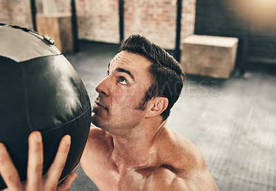 Buy stock photo Fitness, workout and man with medicine ball in gym, healthy and exercise for recovery, strong and athlete. Determined, bodybuilder and training with equipment in club, active and lifting for muscle