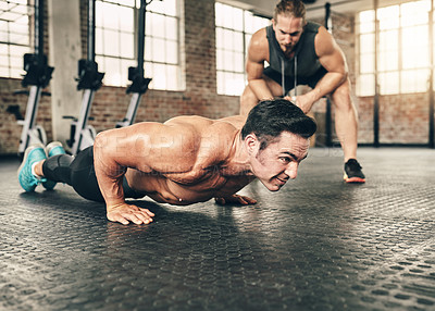 Buy stock photo Fitness, personal trainer and athlete doing a push up exercise for strength, health and wellness. Sports, training and male person doing a body building arm workout with a coach for motivation in gym