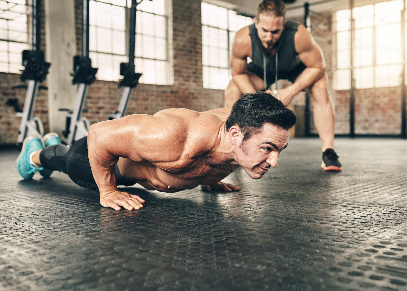 Buy stock photo Fitness, personal trainer and athlete doing a push up exercise for strength, health and wellness. Sports, training and male person doing a body building arm workout with a coach for motivation in gym