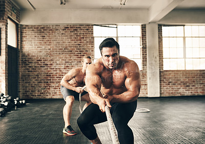 Buy stock photo Men, gym and pull rope for workout with strong muscle, coaching and teamwork for health, fitness and class together. Body builder partnership, focus and tug of war for exercise, wellness and training
