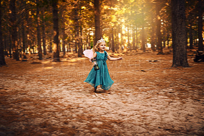 Buy stock photo Shot of a happy little girl holding a lamp while running around  outside in the woods