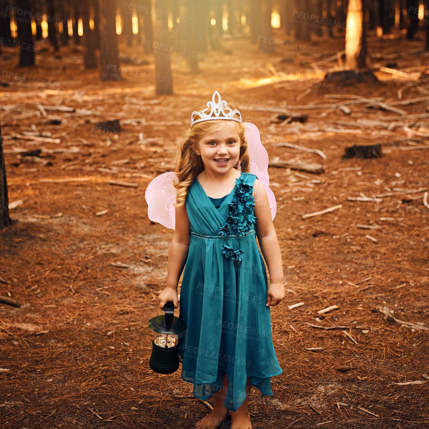 Buy stock photo Shot of a happy little girl looking at the camera and holding a lamp while standing outside in the woods